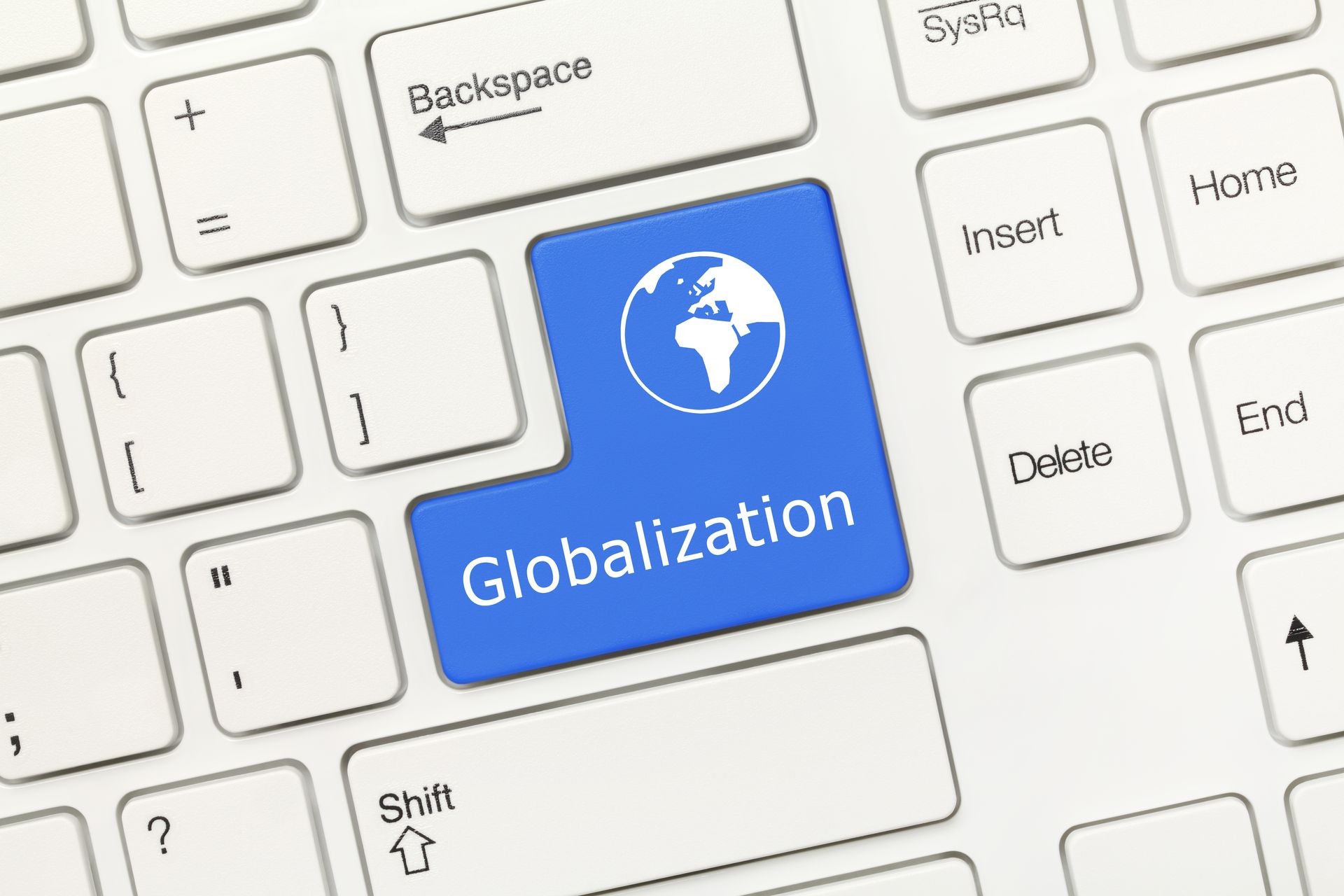 Close-up view on white conceptual keyboard - Globalization (blue key)